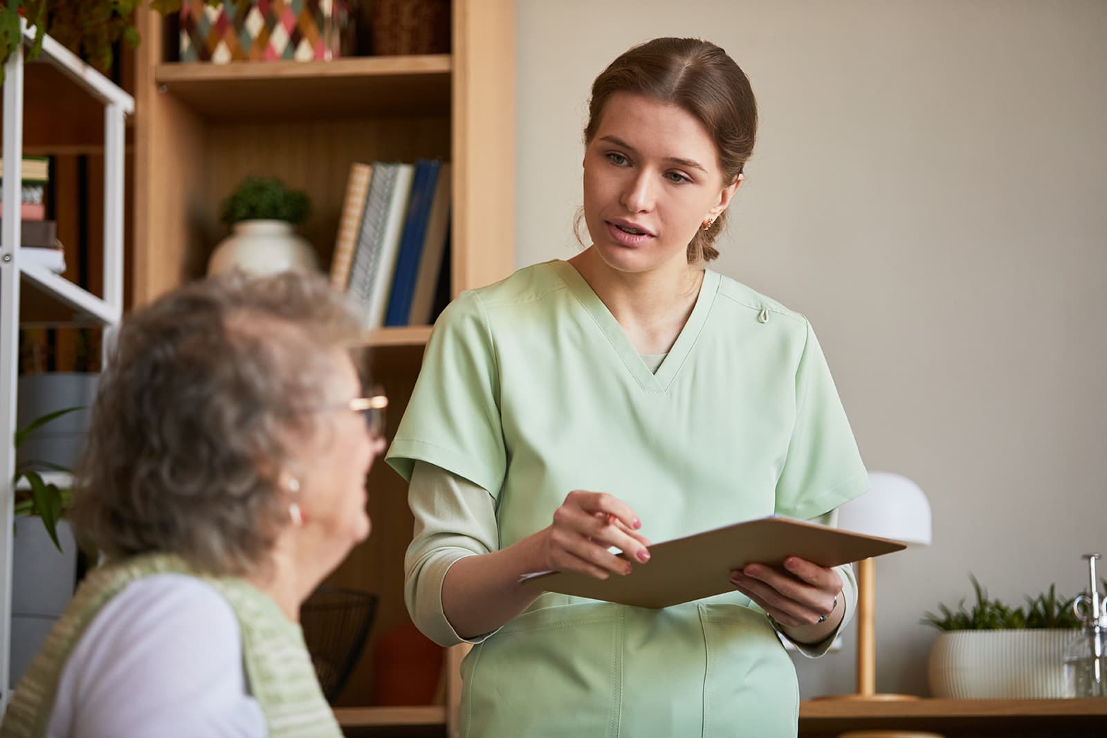 A care coordinator reviewing a care plan with an older adult
